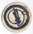 Image of round white felt badge with image of paintbrushes sitting on an artist's palette embroidered in dark blue thread, surrounded by a ring of navy stitching.