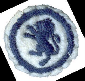 Image of round white felt badge with a logo of a rampant lion embroidered in dark blue thread, within an embroidered dark blue ring.