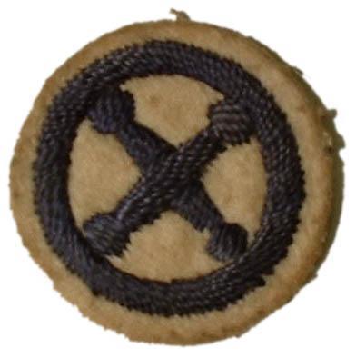 Round white felt badge with logo of crossed dumbbells embroidered in navy thread, within an embroidered navy ring