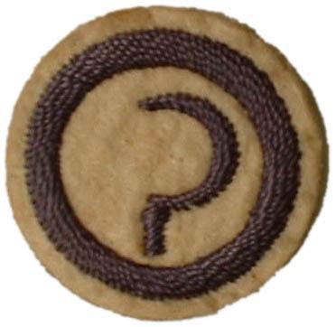 Image of round white felt badge with logo of a sickle embroidered in navy thread within an embroidered navy ring.