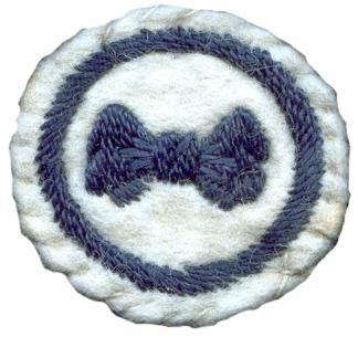 Image of round white felt badge with logo of navy ribbon bow embroidered, within an embroidered navy ring.