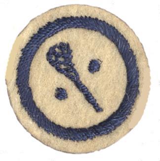 Picture of round white felt badge with logo of lacrosse stick between two balls stitched in dark blue thread, within a dark blue embroidered ring.